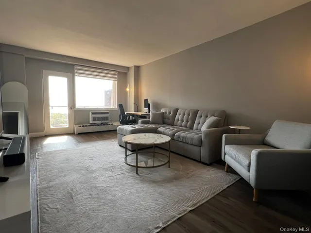 a living room with furniture and a large window