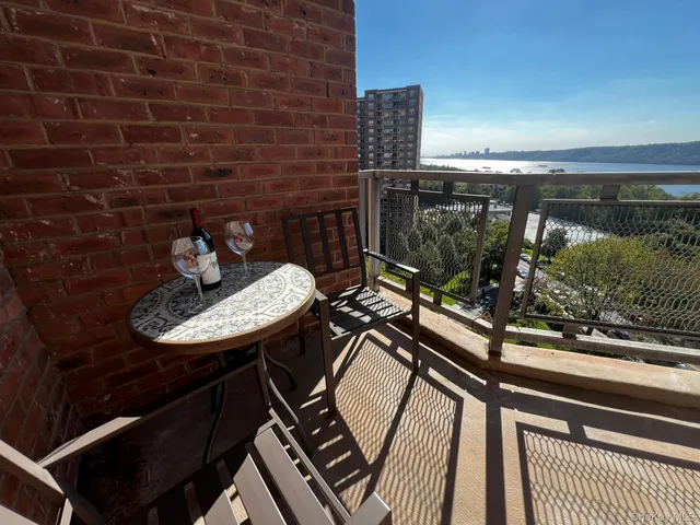 a view of a balcony with two chairs and a table