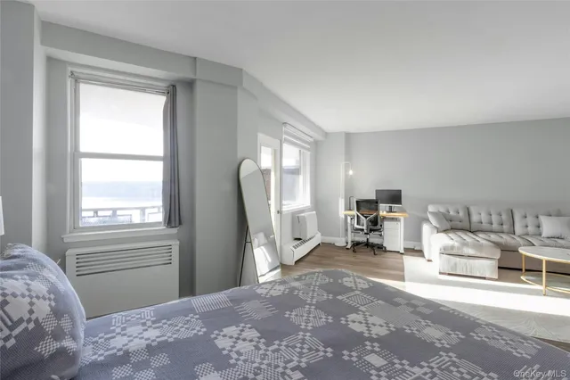 a bedroom with furniture and a window