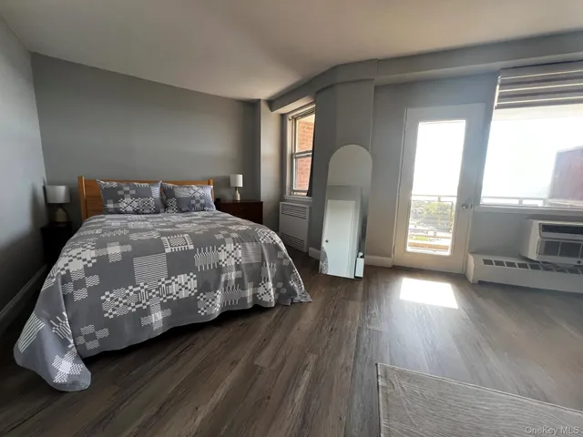 a bedroom with a bed and a large window