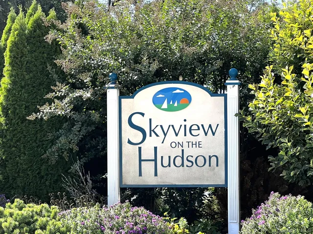 a sign broad in front of red brick house