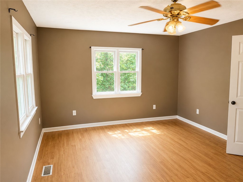 597 Old Hurricane Road Westminster, SC 29693 - Photo 9 of 11 Golden wood floors and warm-toned walls offer a serene retreat.