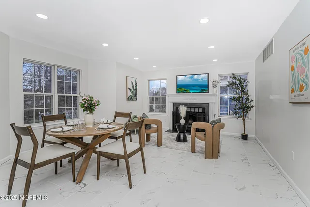 a dining room with furniture and a fireplace