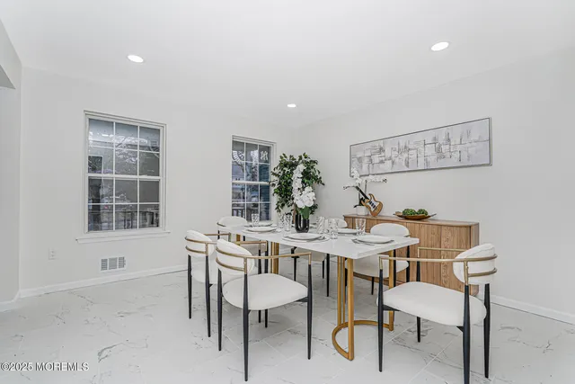 a view of a dining room with furniture and window
