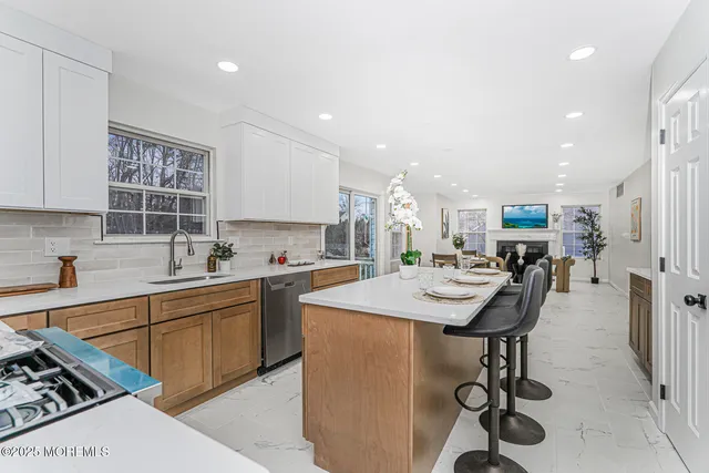 a kitchen with stainless steel appliances kitchen island granite countertop a sink and cabinets