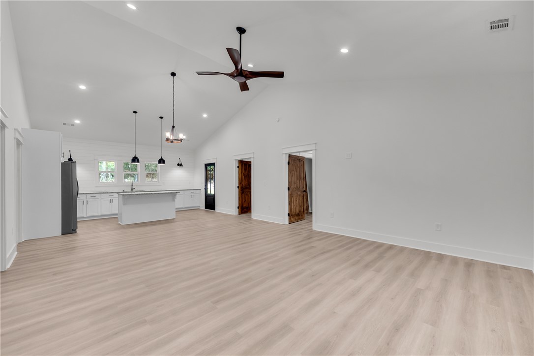 659 White Oak Farms Road Tamassee, SC 29686 - Photo 12 of 50 A spacious layout seamlessly connects the main living area with a modern kitchen.