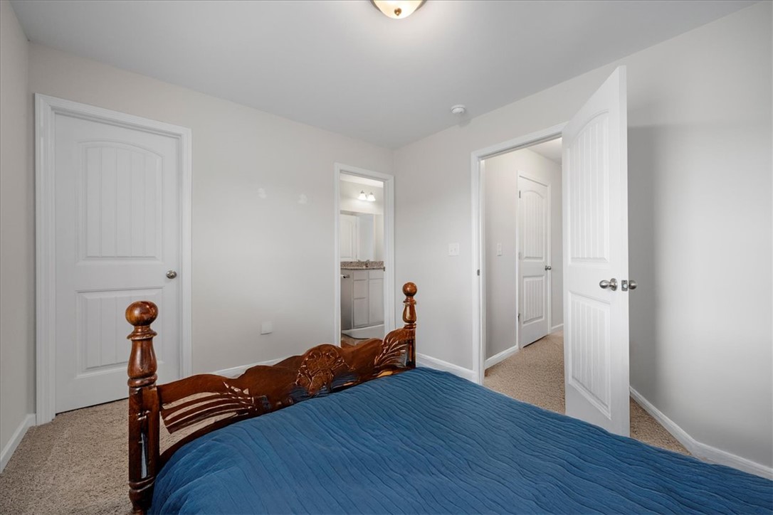 117 Adger Road Pendleton, SC 29670 - Photo 26 of 36 This spacious bedroom offers comfortable living with carpet flooring and access to a well-appointed bathroom.