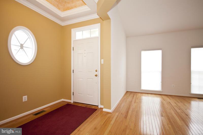 8603 Snowreath Road, Unit 8603 Baltimore, MD 21208 - Photo 2 of 30 an empty room with wooden floor and windows
