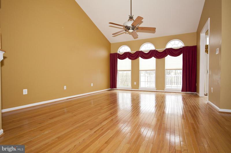 8603 Snowreath Road, Unit 8603 Baltimore, MD 21208 - Photo 13 of 30 a view of an empty room with wooden floor and a window