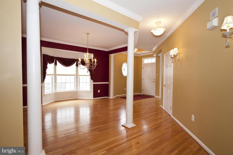 8603 Snowreath Road, Unit 8603 Baltimore, MD 21208 - Photo 14 of 30 a view of a hallway with wooden floor and a glass door