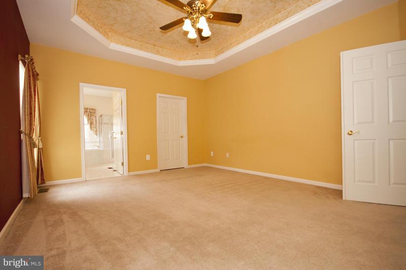 8603 Snowreath Road, Unit 8603 Baltimore, MD 21208 - Photo 16 of 30 an empty room with fan and entrance