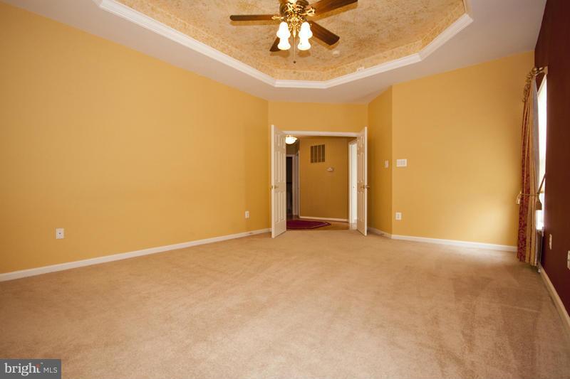 8603 Snowreath Road, Unit 8603 Baltimore, MD 21208 - Photo 17 of 30 a view of an empty room with a chandelier fan