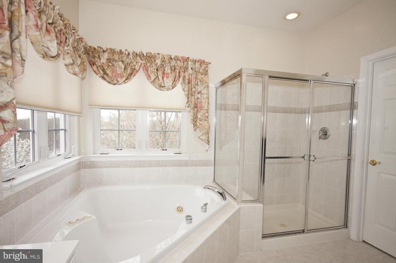 8603 Snowreath Road, Unit 8603 Baltimore, MD 21208 - Photo 18 of 30 a bathroom with a bathtub and a shower