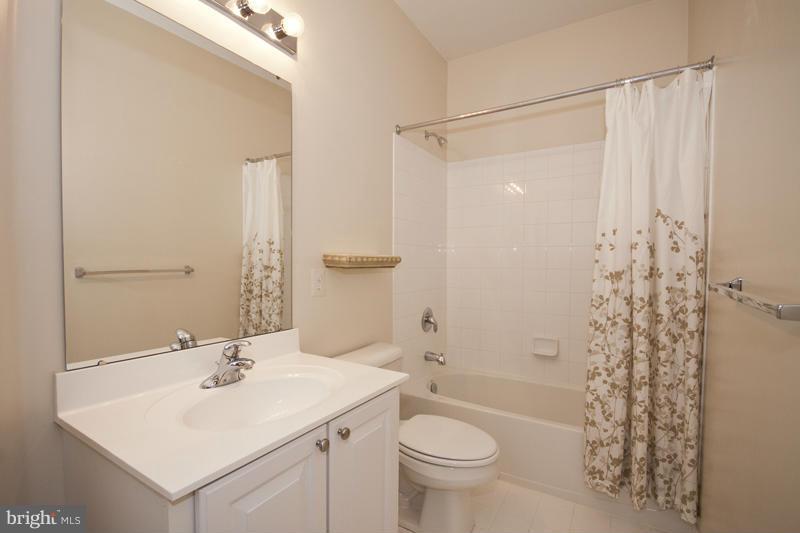 8603 Snowreath Road, Unit 8603 Baltimore, MD 21208 - Photo 20 of 30 a bathroom with a sink toilet and shower