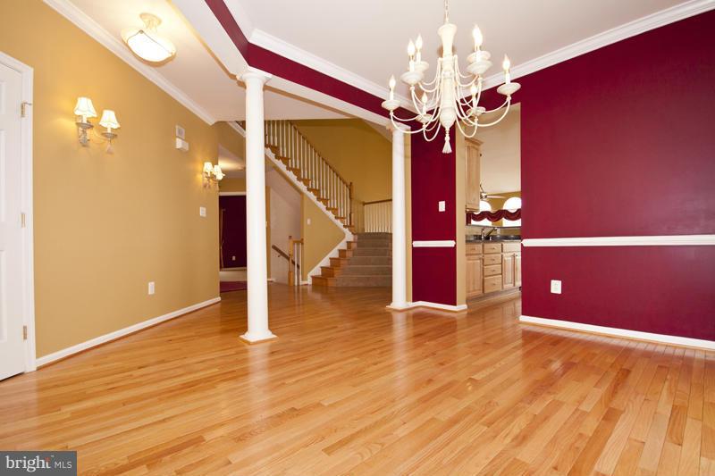 8603 Snowreath Road, Unit 8603 Baltimore, MD 21208 - Photo 6 of 30 a view of a livingroom with wooden floor and chandelier
