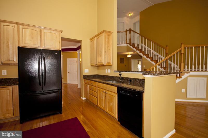8603 Snowreath Road, Unit 8603 Baltimore, MD 21208 - Photo 8 of 30 a kitchen with stainless steel appliances granite countertop a refrigerator a stove and a sink