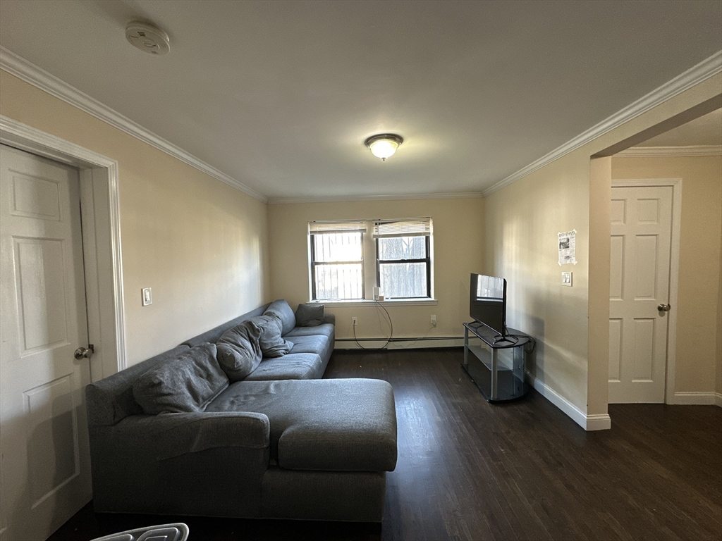 435 Walnut Avenue, Unit A Boston, MA 02119 - Photo 2 of 12 a living room with furniture window and wooden floor