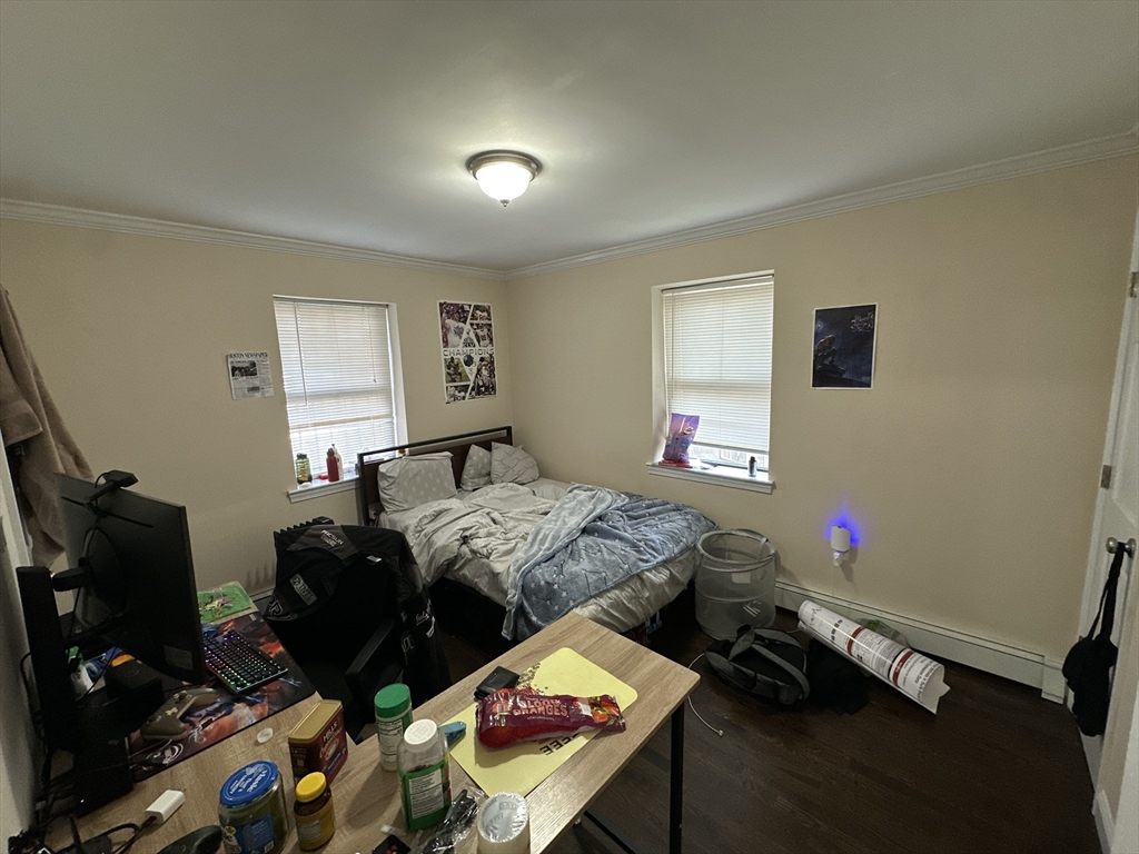 435 Walnut Avenue, Unit A Boston, MA 02119 - Photo 10 of 12 a bedroom with bed and a window