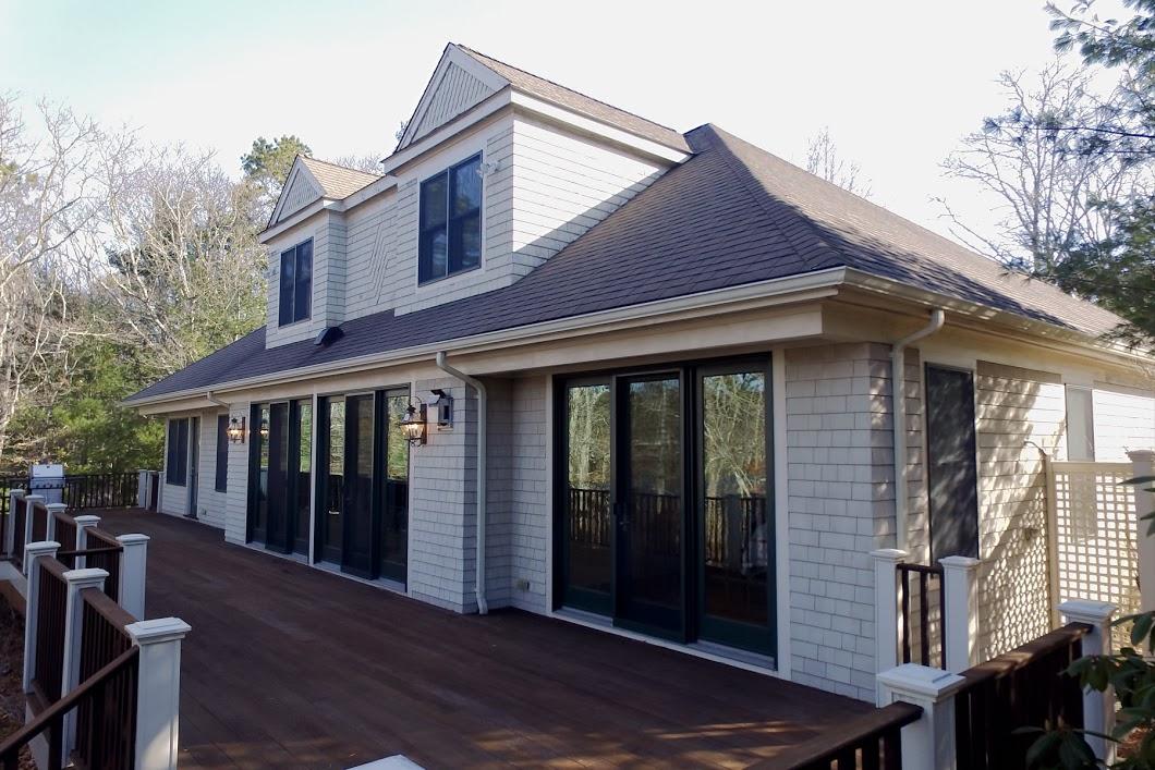 194 Fells Pond Road Mashpee, MA 02649 - Photo 1 of 34 a view of wooden house with large windows and a table