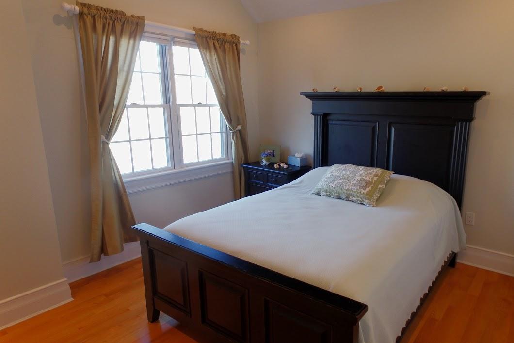 194 Fells Pond Road Mashpee, MA 02649 - Photo 23 of 34 a bed sitting in a bedroom next to a window
