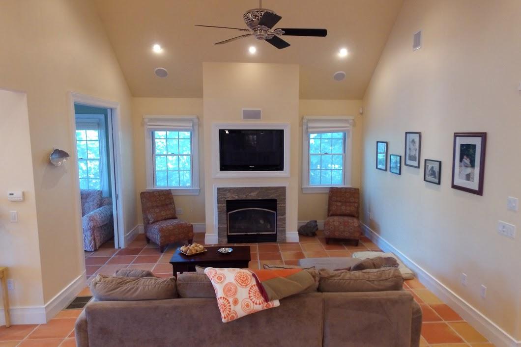 194 Fells Pond Road Mashpee, MA 02649 - Photo 8 of 34 a living room with furniture a flat screen tv and a fireplace