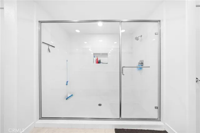 a bathroom with a glass shower door