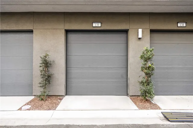a small white building with a potted plant