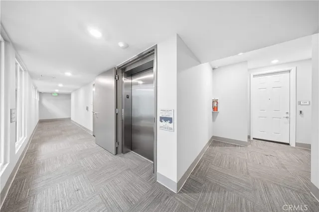 a view of hallway with wooden floor