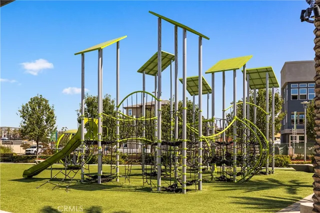 a view of swimming pool with lawn chairs and potted plants
