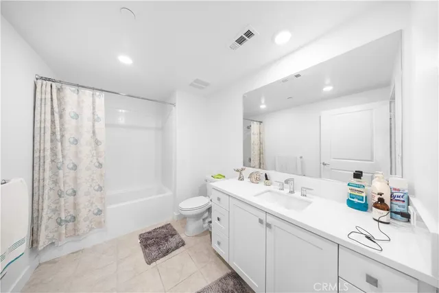 a bathroom with a double vanity sink toilet and shower