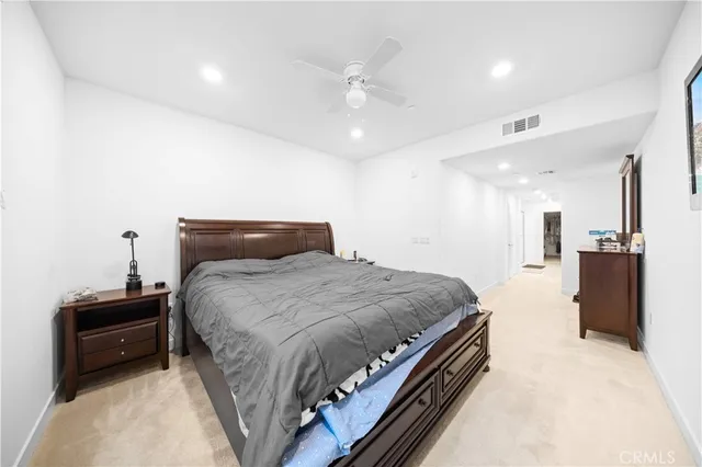 a bedroom with a bed and a ceiling fan