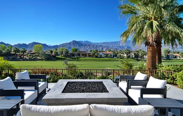 a view of a patio with couches under an umbrella