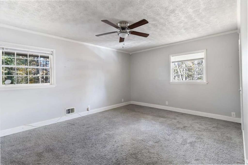 1999 Lindsey Lane Decatur, GA 30035 - Photo 15 of 38 an empty room with a window and a ceiling fan