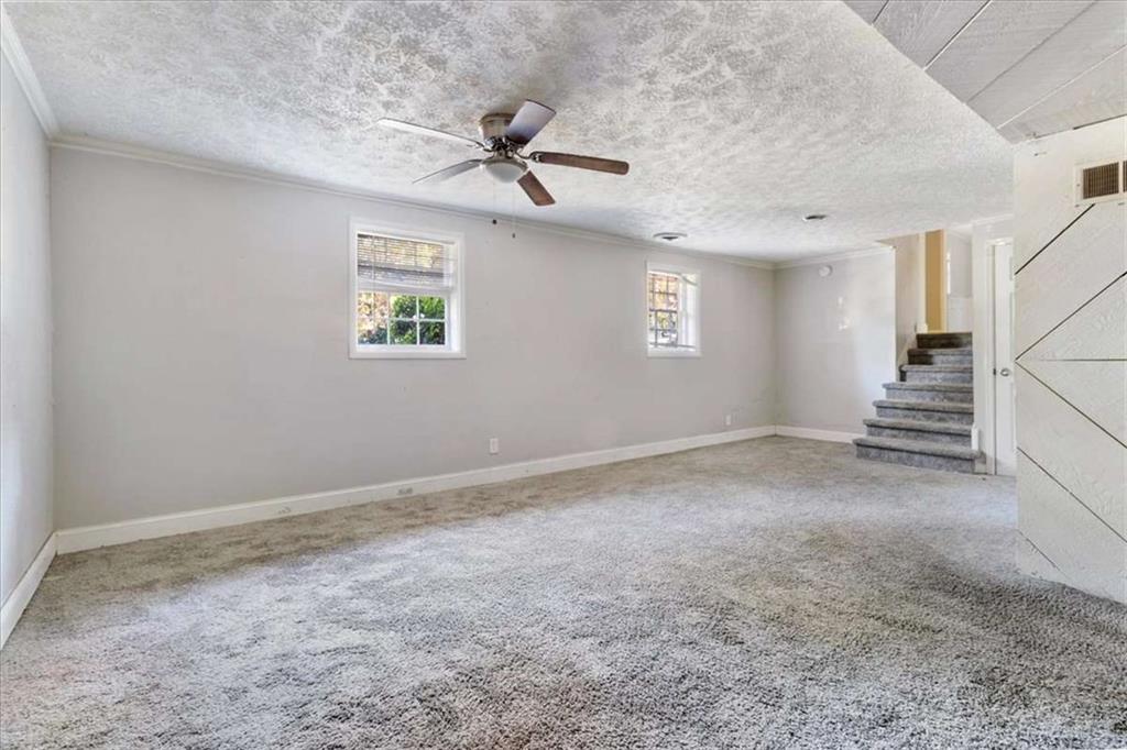1999 Lindsey Lane Decatur, GA 30035 - Photo 25 of 38 en empty room with windows and ceiling fan