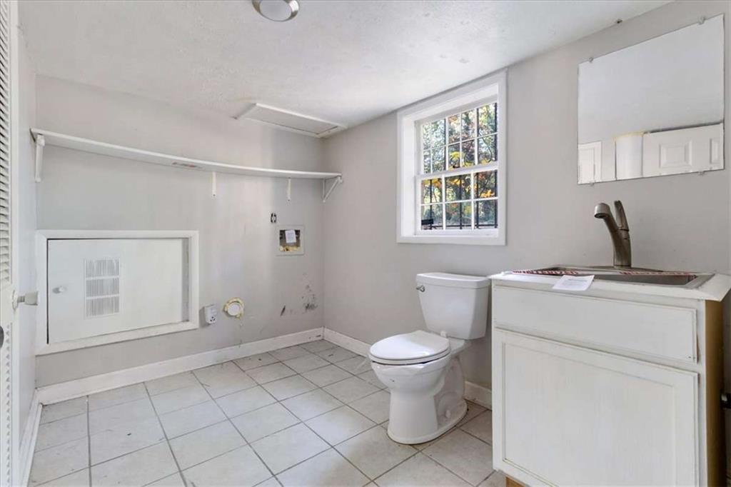 1999 Lindsey Lane Decatur, GA 30035 - Photo 26 of 38 a bathroom with a granite countertop sink toilet and shower