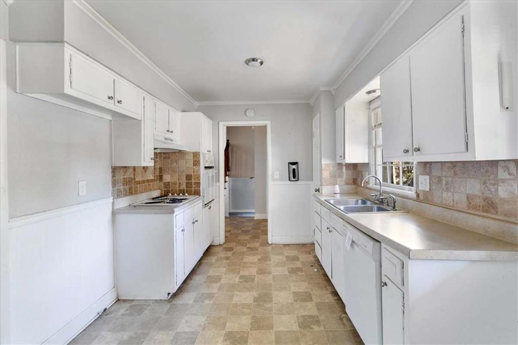 1999 Lindsey Lane Decatur, GA 30035 - Photo 9 of 38 a large kitchen with a stove top oven a sink a microwave and cabinets