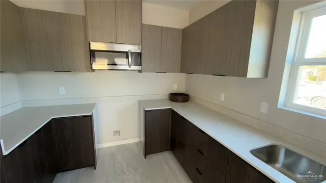a kitchen with a sink and a refrigerator