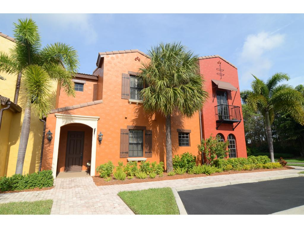 8997 Cambria Circle, Unit 2002 Naples, FL 34113 - Photo 1 of 18 a front view of a house with a yard and garage
