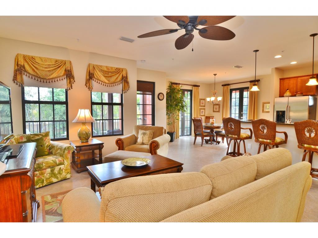 8997 Cambria Circle, Unit 2002 Naples, FL 34113 - Photo 2 of 18 a living room with furniture potted plant and a chandelier
