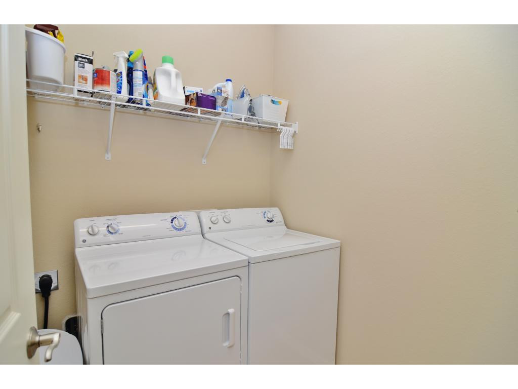 8997 Cambria Circle, Unit 2002 Naples, FL 34113 - Photo 12 of 18 a utility room with dryer and washer