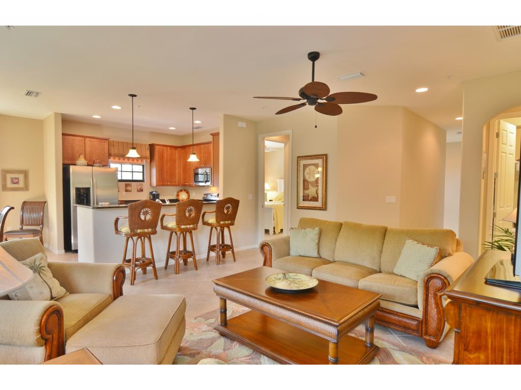 8997 Cambria Circle, Unit 2002 Naples, FL 34113 - Photo 4 of 18 a living room with furniture and kitchen view