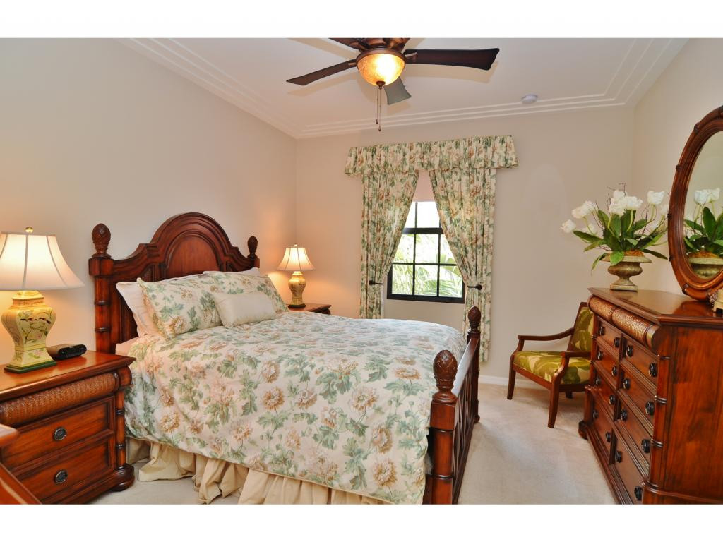 8997 Cambria Circle, Unit 2002 Naples, FL 34113 - Photo 8 of 18 a bedroom with furniture and a window