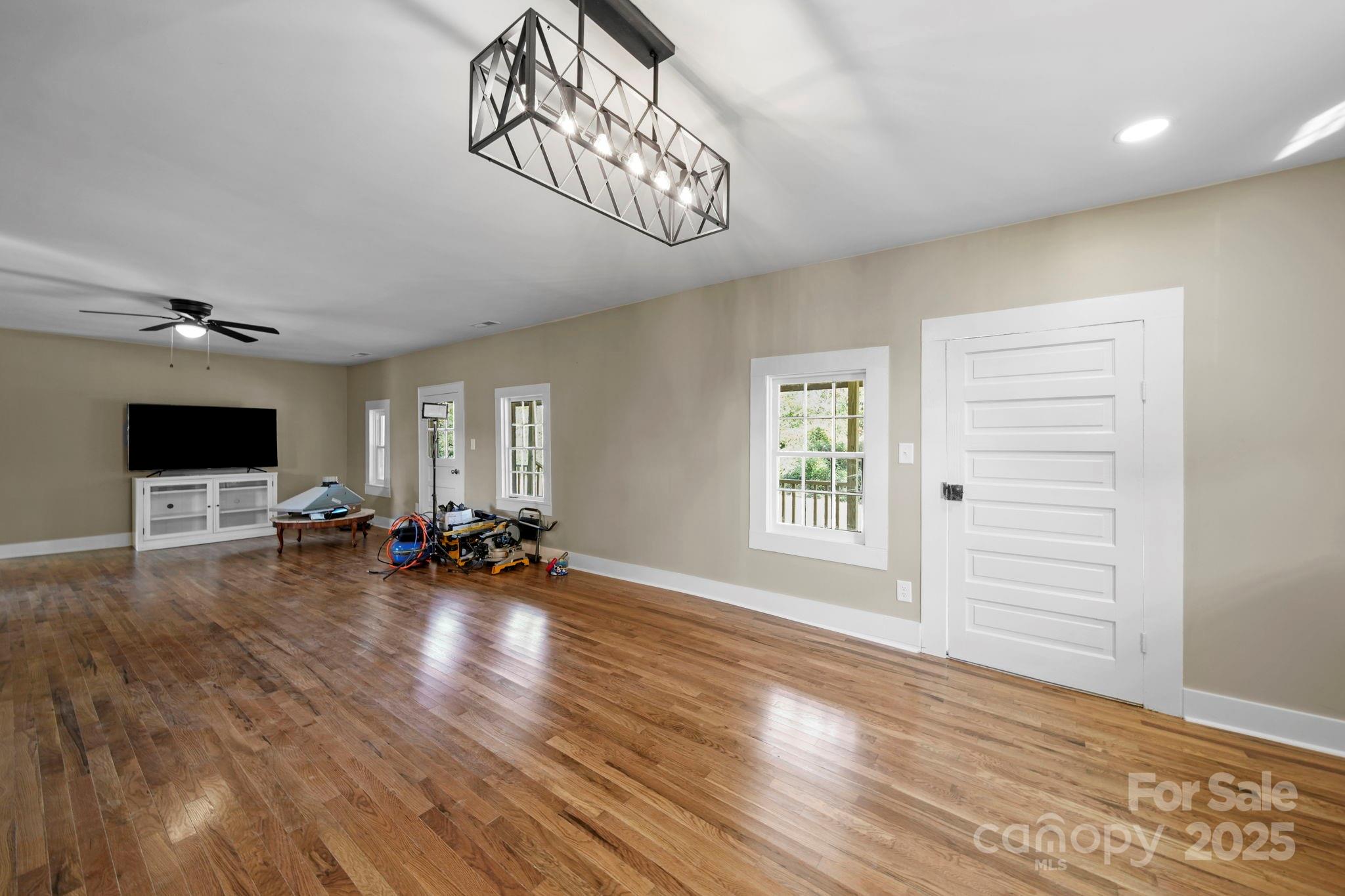 1048 Bowers Road Peachland, NC 28133 - Photo 13 of 44 a view of a livingroom with wooden floor and a flat screen tv