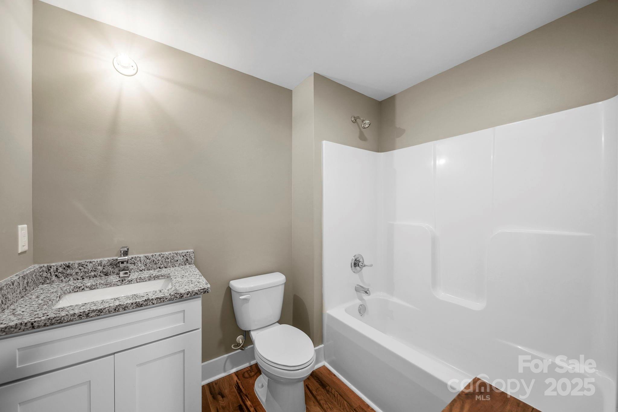 1048 Bowers Road Peachland, NC 28133 - Photo 27 of 44 a bathroom with a granite countertop sink a toilet and bathtub