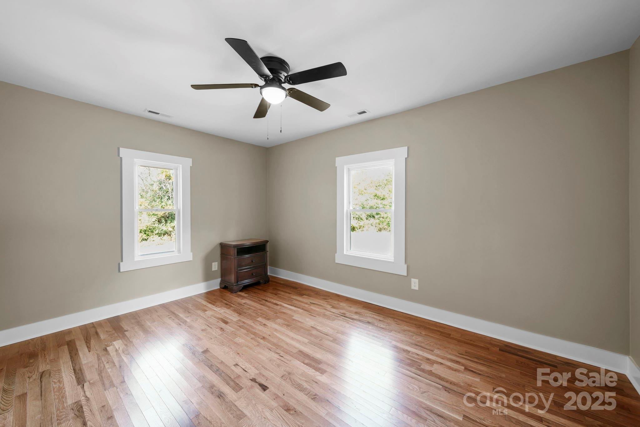 1048 Bowers Road Peachland, NC 28133 - Photo 31 of 44 a view of an empty room with a window and wooden floor