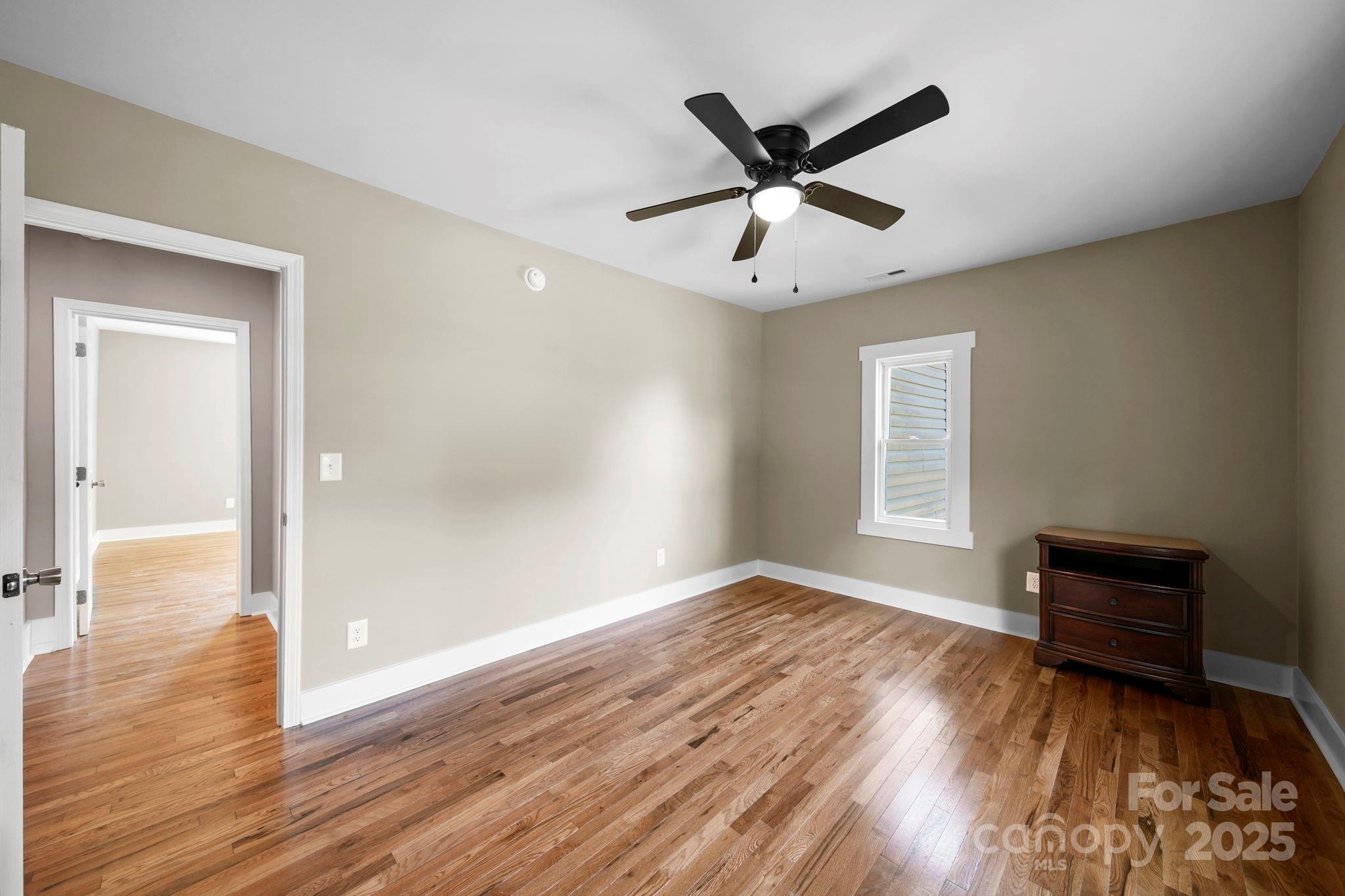 1048 Bowers Road Peachland, NC 28133 - Photo 32 of 44 a view of a livingroom with wooden floor and a ceiling fan