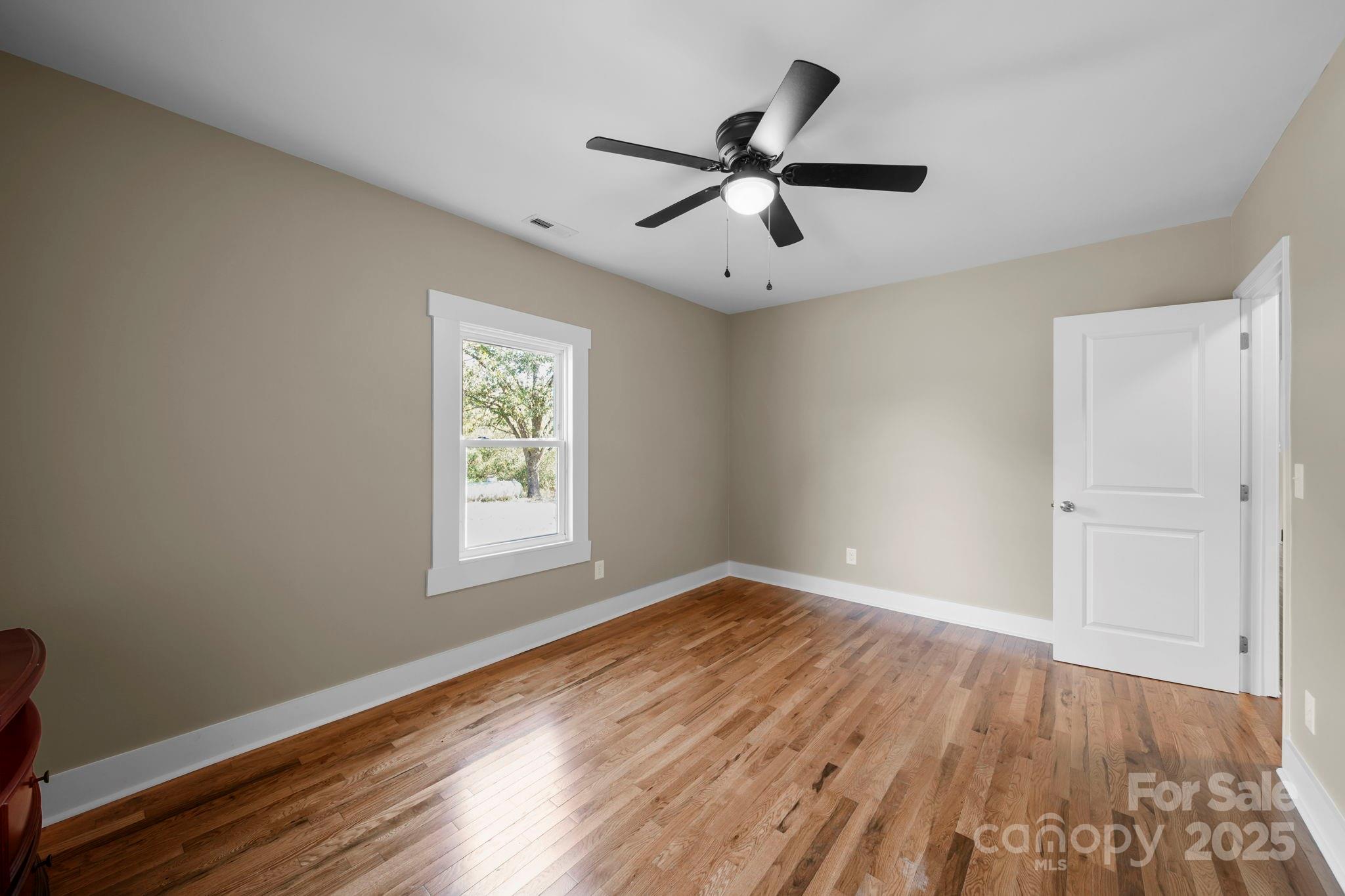 1048 Bowers Road Peachland, NC 28133 - Photo 33 of 44 a view of an empty room with wooden floor and a window