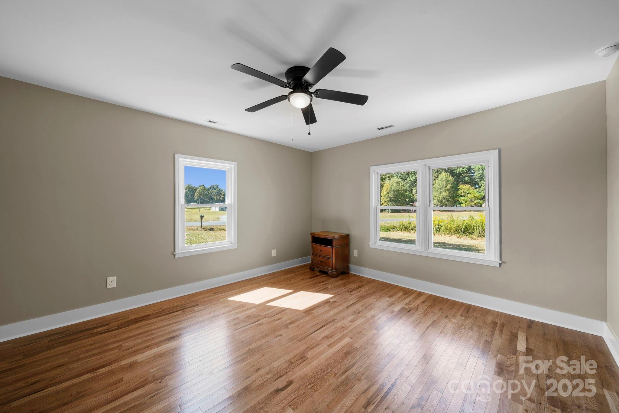1048 Bowers Road Peachland, NC 28133 - Photo 34 of 44 a view of an empty room with wooden floor and a window