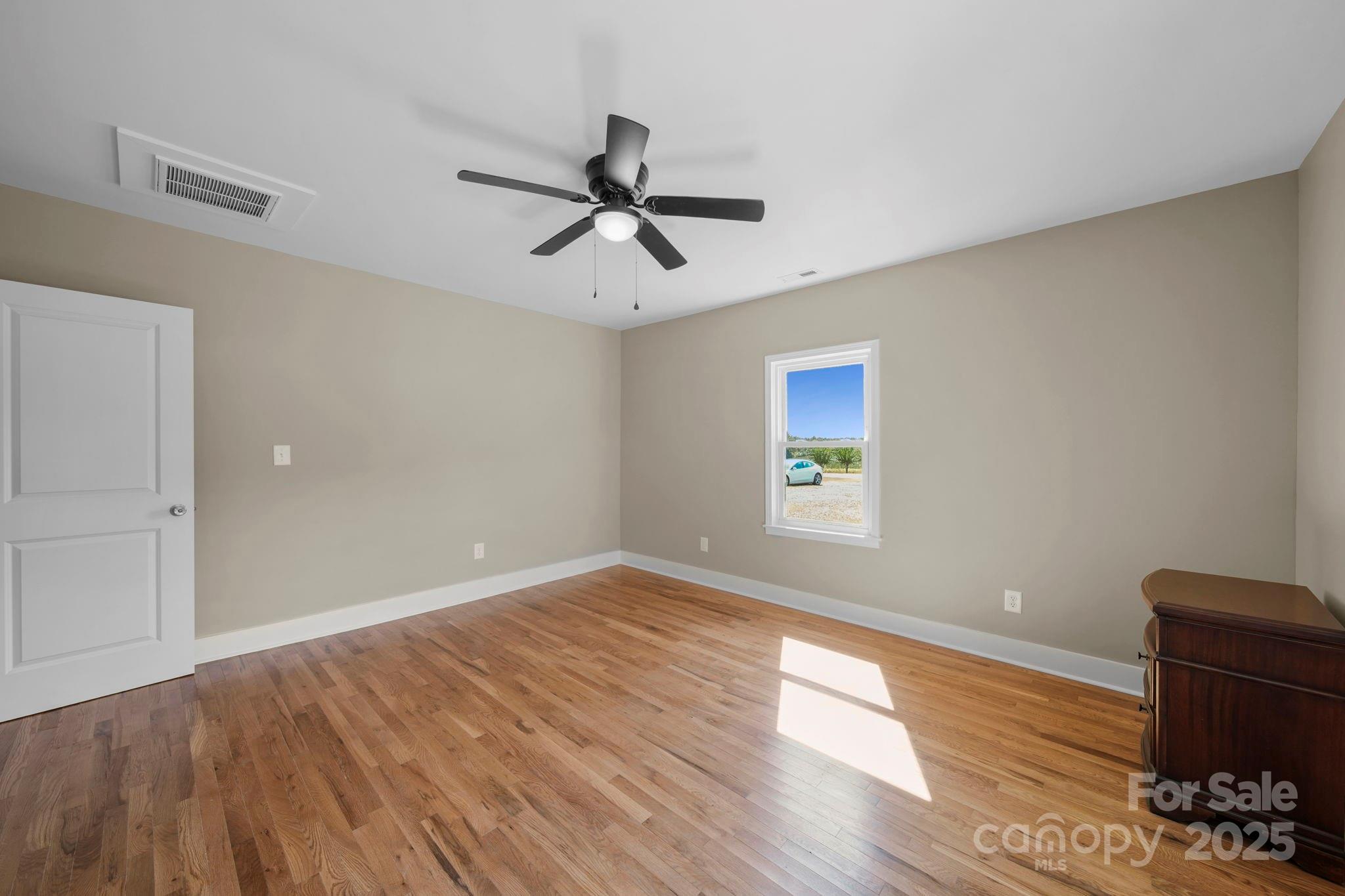 1048 Bowers Road Peachland, NC 28133 - Photo 36 of 44 a view of empty room with wooden floor and fan
