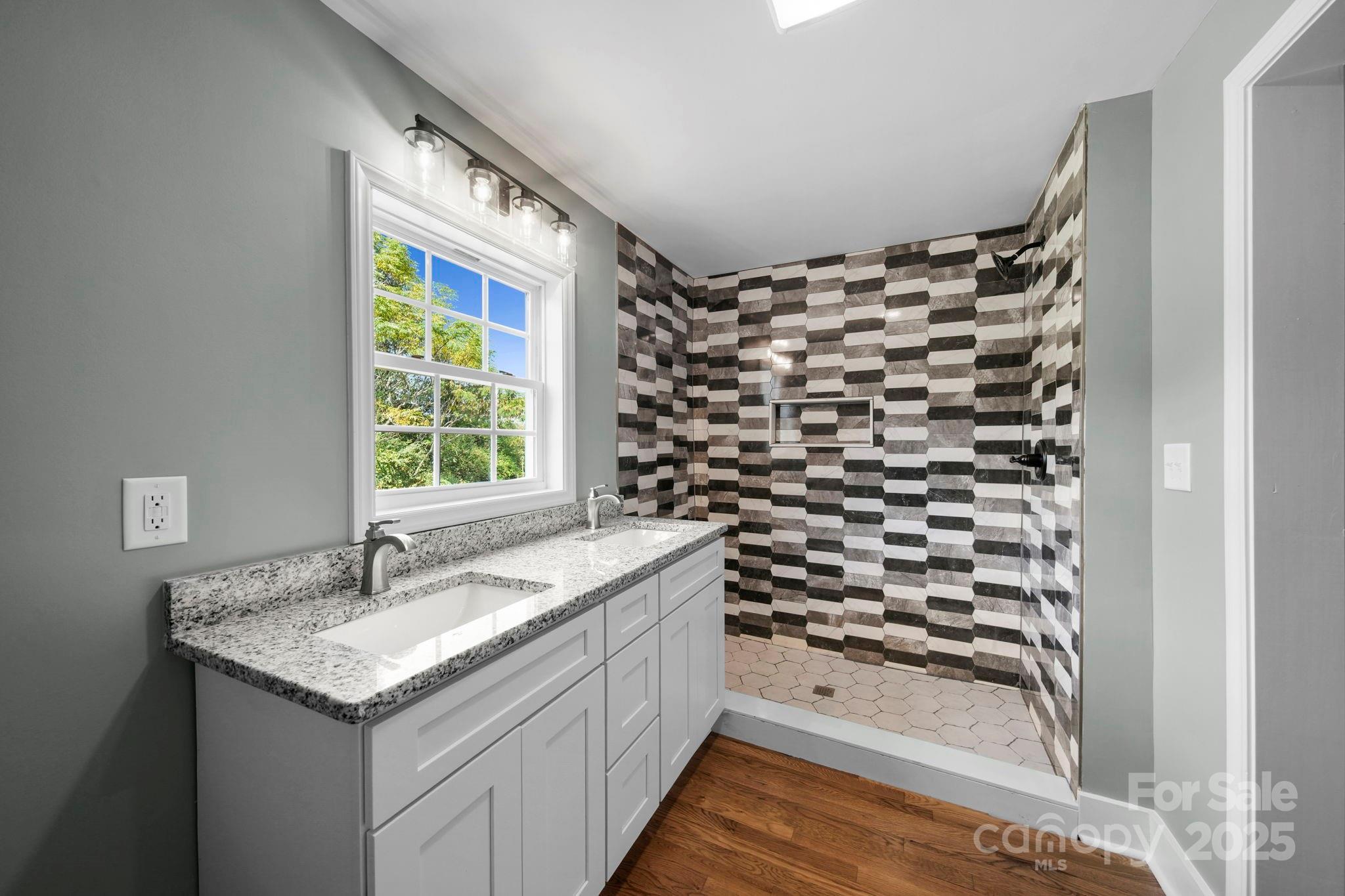 1048 Bowers Road Peachland, NC 28133 - Photo 39 of 44 a bathroom with a granite countertop sink a vanity and a shower